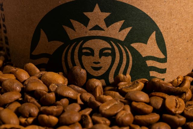 Starbucks logo with some coffee beans. 