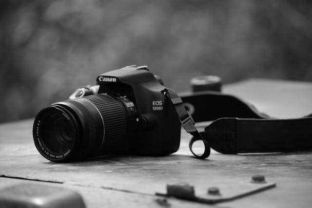 A monochrome photo of a Canon DSLR camera. 