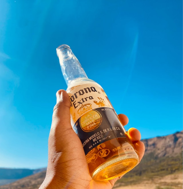 A bottle of Corona against a blue sky. 