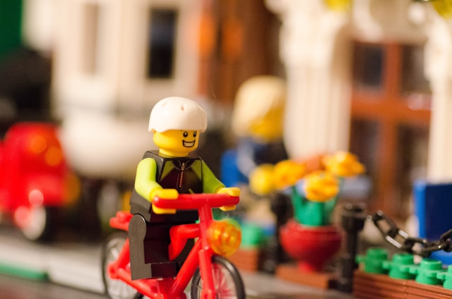 Lego model of a man on a bicycle. 