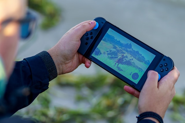 A person playing a videogame on a Nintendo Switch console. 