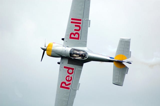 A stunt plane with Red Bull branding. 
