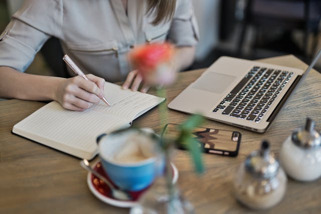 Somebody writing an inbound marketing plan at a desk. 