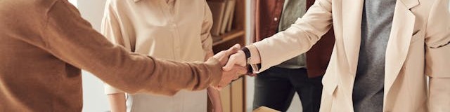 Business meeting - people shaking hands.