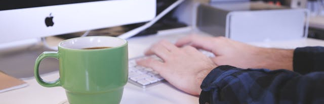 Hands typing on a keyboard.