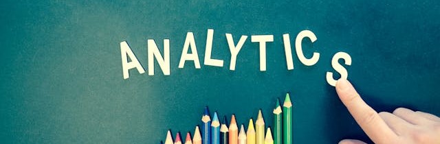 The word "analytics" spelled out on a chalkboard.