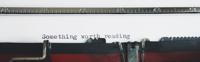 The words "something worth reading" typed onto paper.