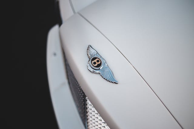 Hood badge on a white Bentley.