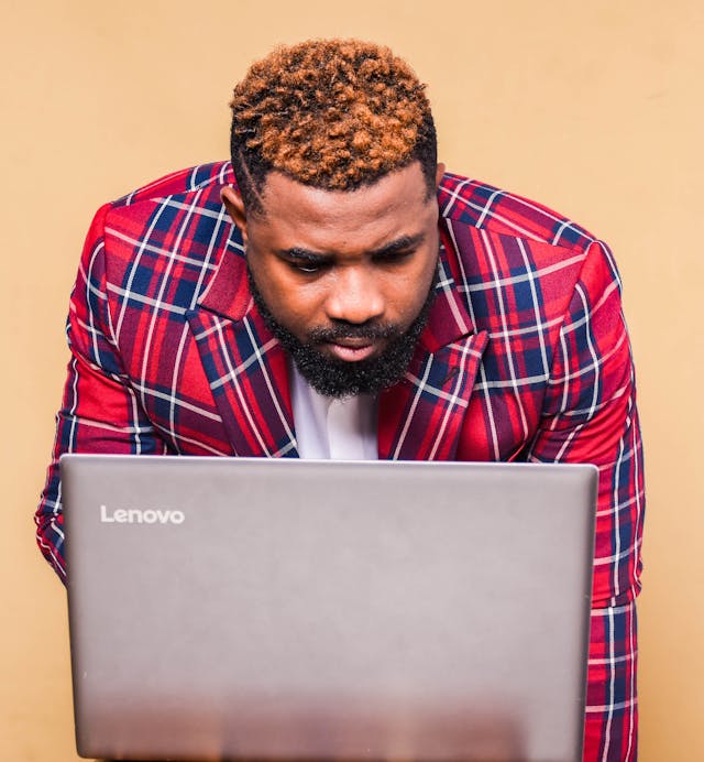 A man looking at a Lenovo laptop screen