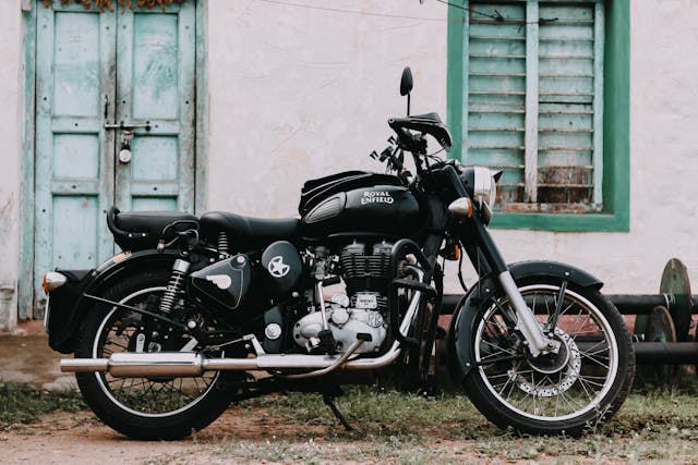 Side view of a Royal Enfield Classic 350 motorcycle in black color scheme.